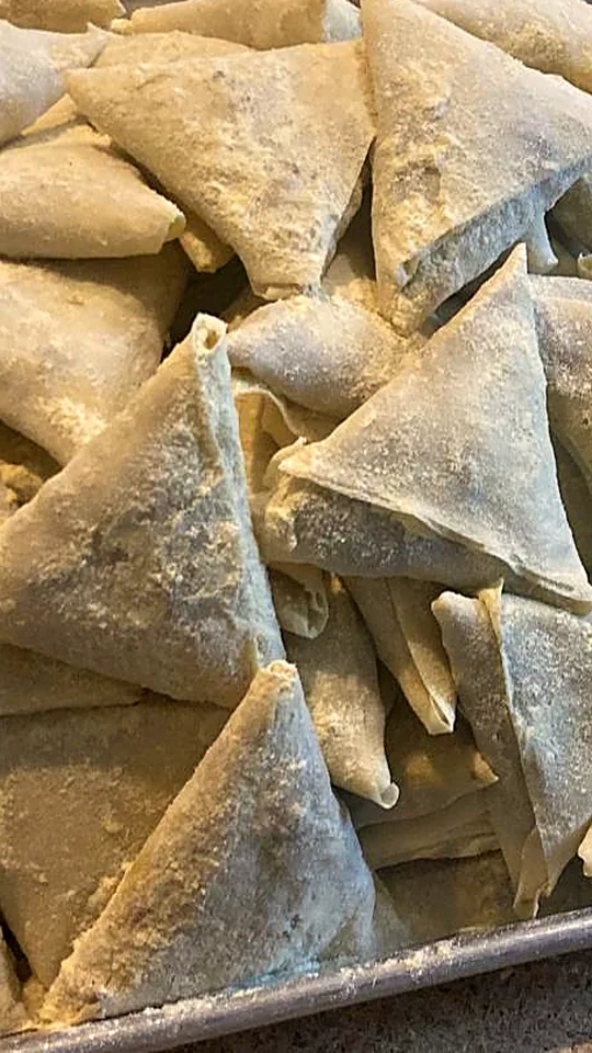 Samosas folded by hand